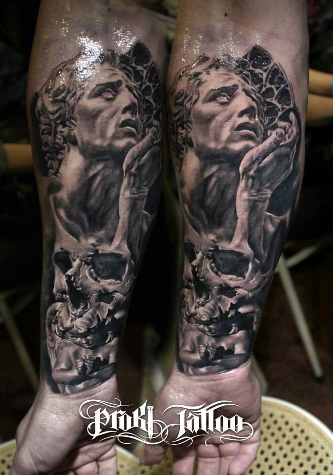 Skull and statue tattoo on arm