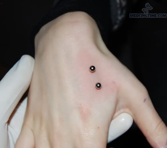 Silver Barbell Hand Piercing