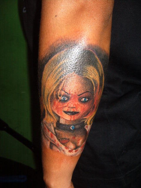 Colorful Chucky Bride Tattoo On Forearm By Jimmy