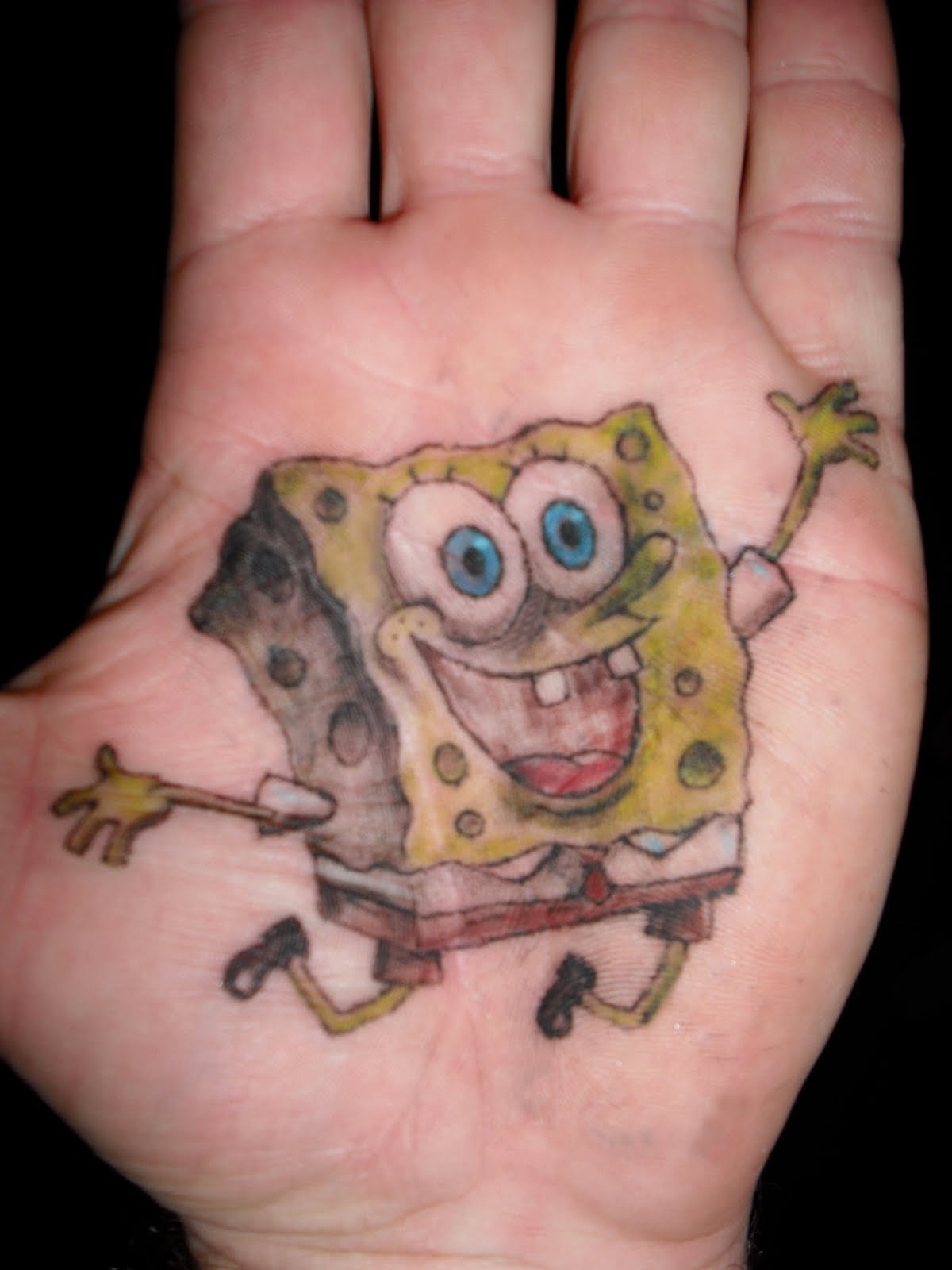 Colorful Spongebob Cartoon Tattoo On Hand