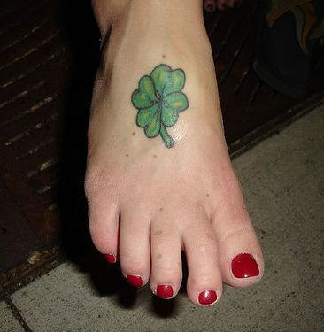 Green Clover Leaf Tattoo On Girl Foot