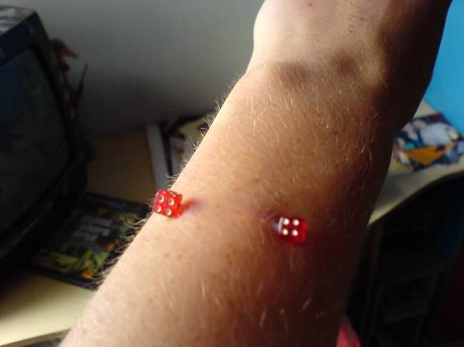 Arm Piercing with Surface Red Dice Barbell