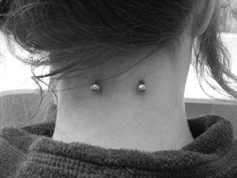 Black and White Surface Nape Piercing Image