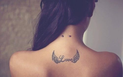 Winged Love Word Tattoo On Upper Back  And Surface Nape Piercing