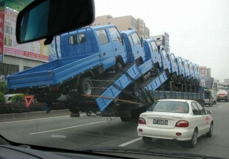 Mini Truck Falling From Large Truck Funny Picture