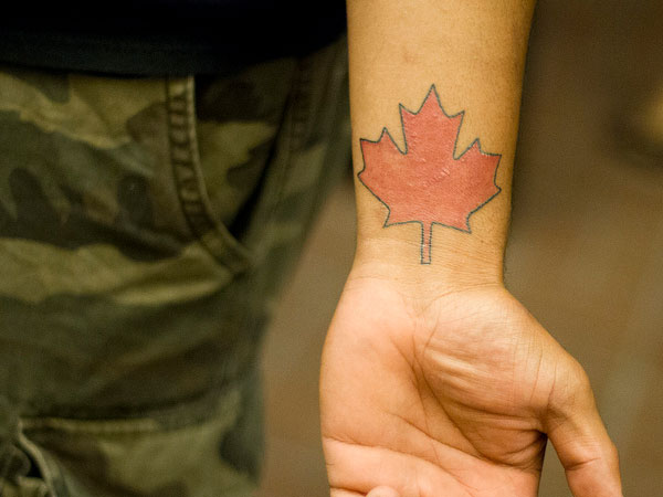 Red Maple Leaf Tattoo On Left Wrist