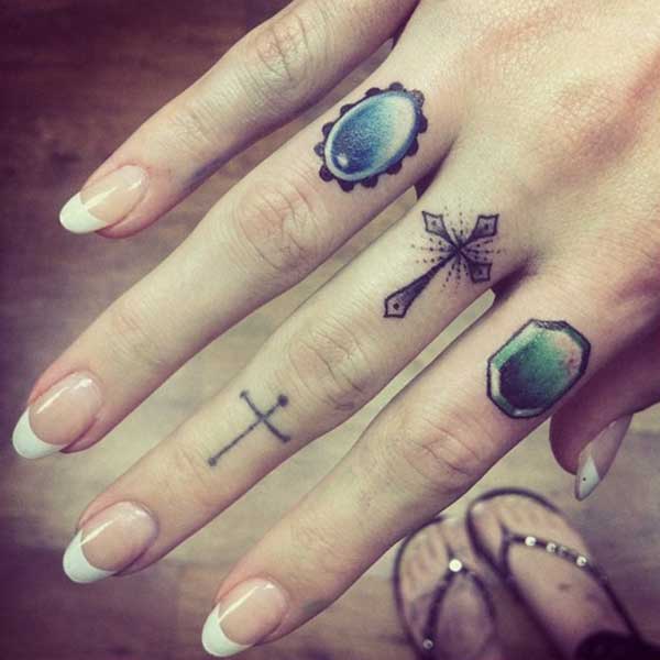 Diamond Jewels And Cross Tattoos On Fingers