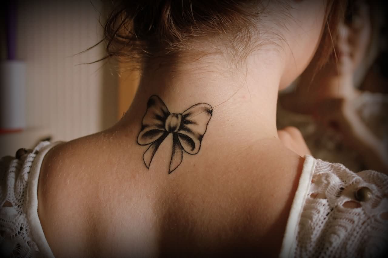 Black Ink Ribbon Bow Tattoo On Girl Back Neck