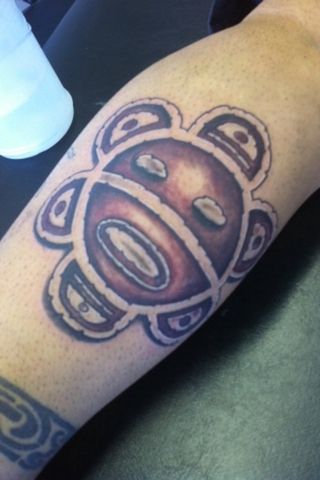 Grey Ink Taino Sun Tattoo On Leg