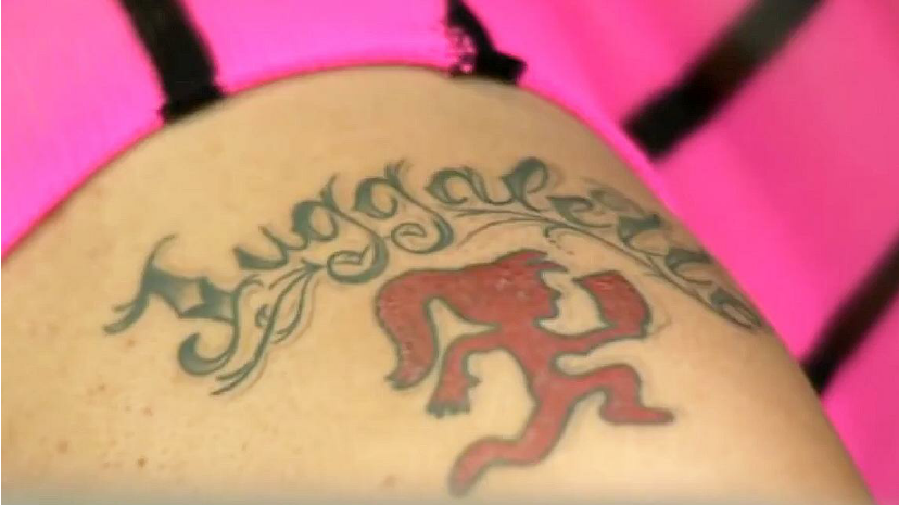 Red Ink Jugalette Tattoo Closeup Image