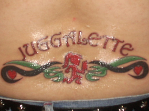 Red Ink Jugalette Tattoo On Lower Back