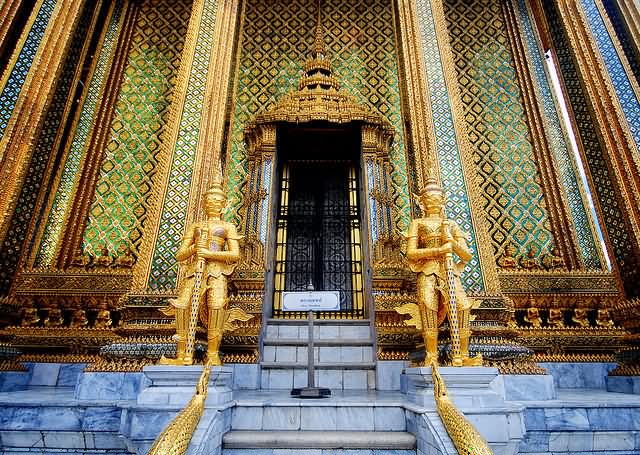 Golden Guards Outside Temple In Grand Palace