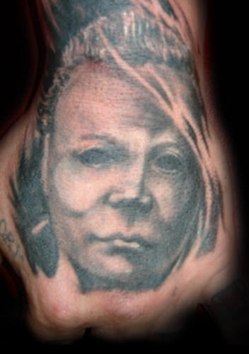 Grey Ink People Portrait Tattoo On Hand