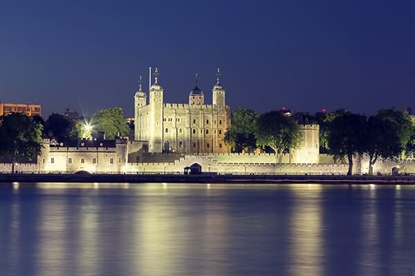 View Of The Tower Of London At Night From The South Bank Of River Thames