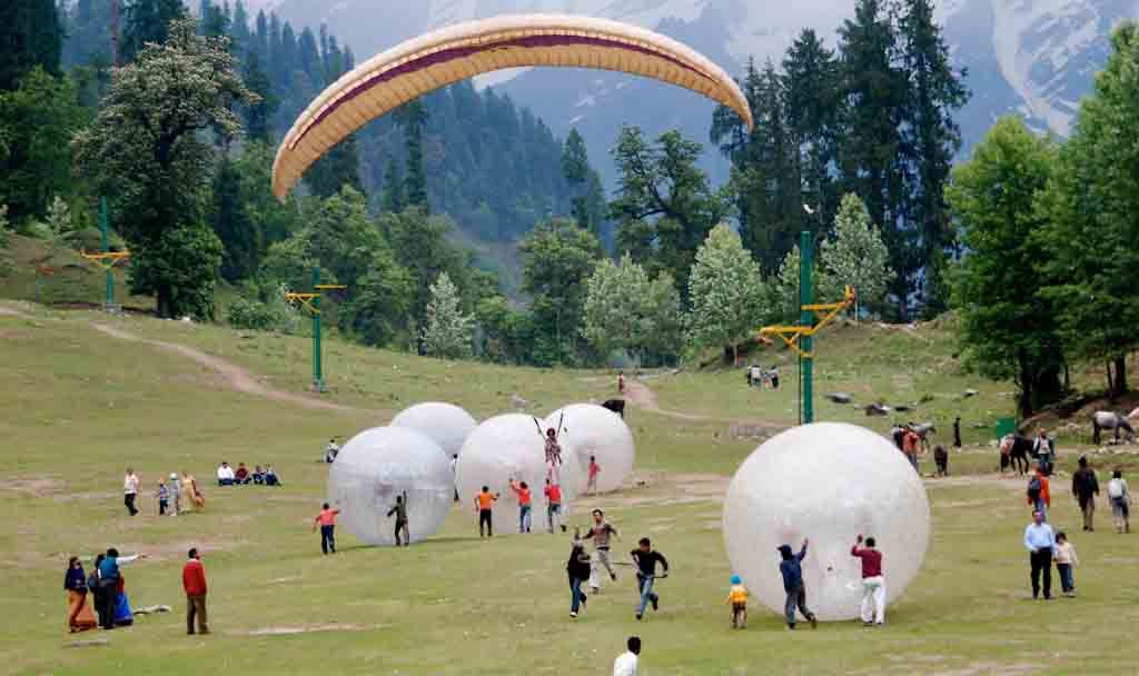 Tourists Enjoying Zorbing And Paragliding At The Solang Valley