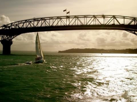 Yacht Passing Under The Auckland Harbour Bridge