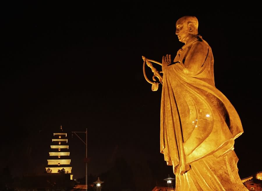 Beautiful Statue In Front Of Giant Wild Goose Pagoda During Night