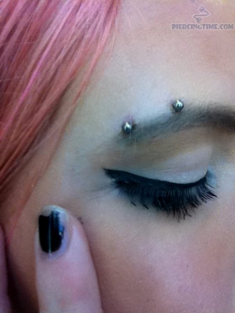 Surface Cat Eye Piercing With Silver Barbell