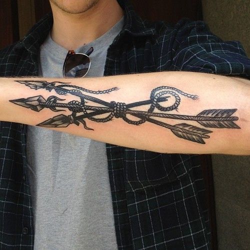 Black Ink Arrows Tattoo On Man Left Forearm