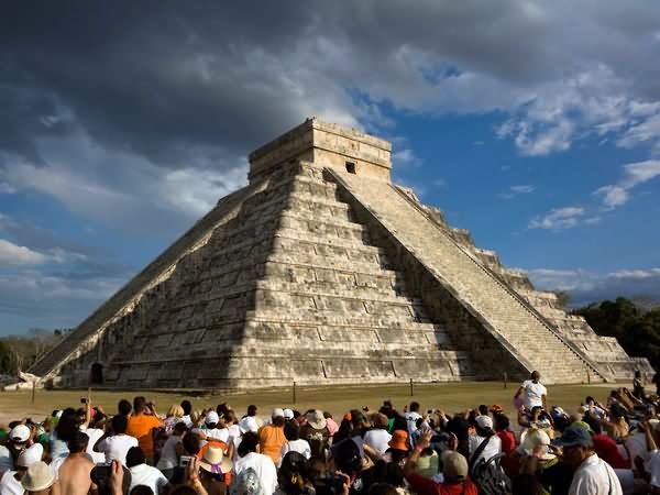 People Sitting Around El Castillo In Chichen Itza