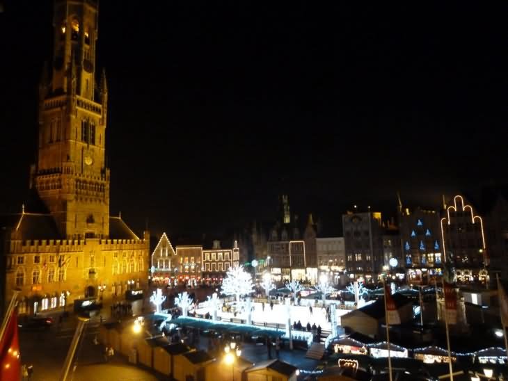 The Belfry Tower And Grote Market Illuminated At Night During Christmas