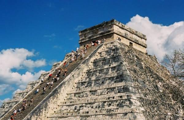 Tourists Walking On The Stairs Of The El Castillo In Mexico