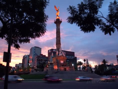 Traffic Passes By The Angel Of Independence Monument At Dusk