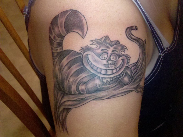 Grey Ink Cheshire Cat Tattoo On Right Shoulder