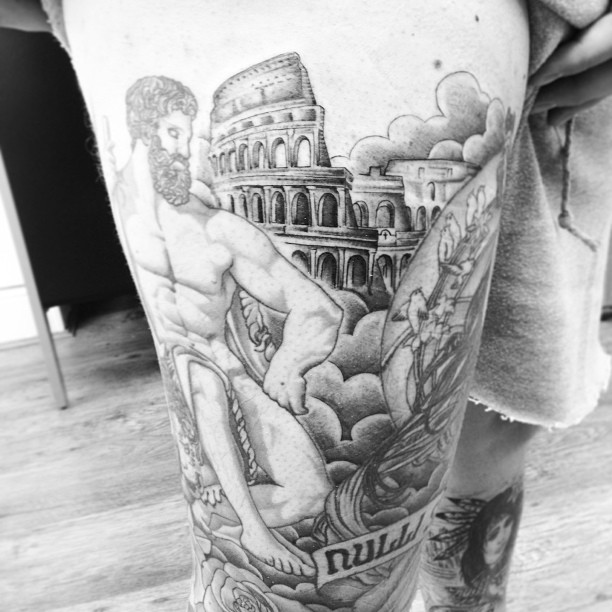 Grey Ink Colosseum Tattoo On Thigh