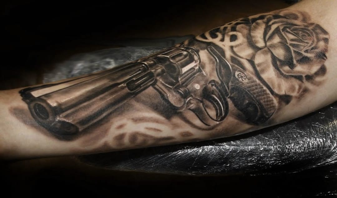 Grey Rose And Revolver Tattoo On Sleeve