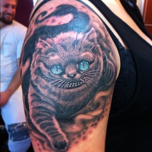 Right shoulder Blue Ink Cheshire Cat Tattoo