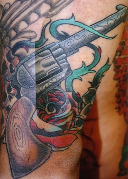 Rose Flower And Revolver Tattoo On Sleeve