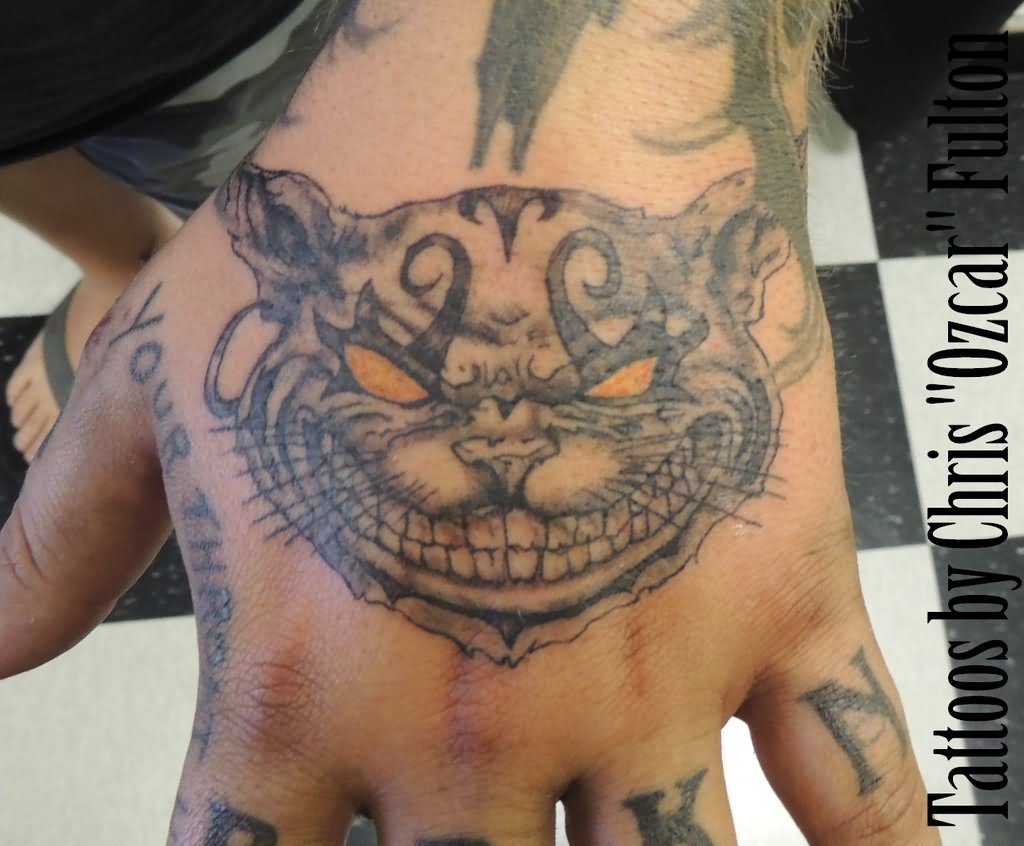 Yellow Eyes Cheshire Cat Tattoo On Left Hand by Chrisozfulton