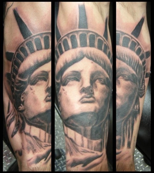 Black And Grey Statue Of Liberty Face Tattoo Design