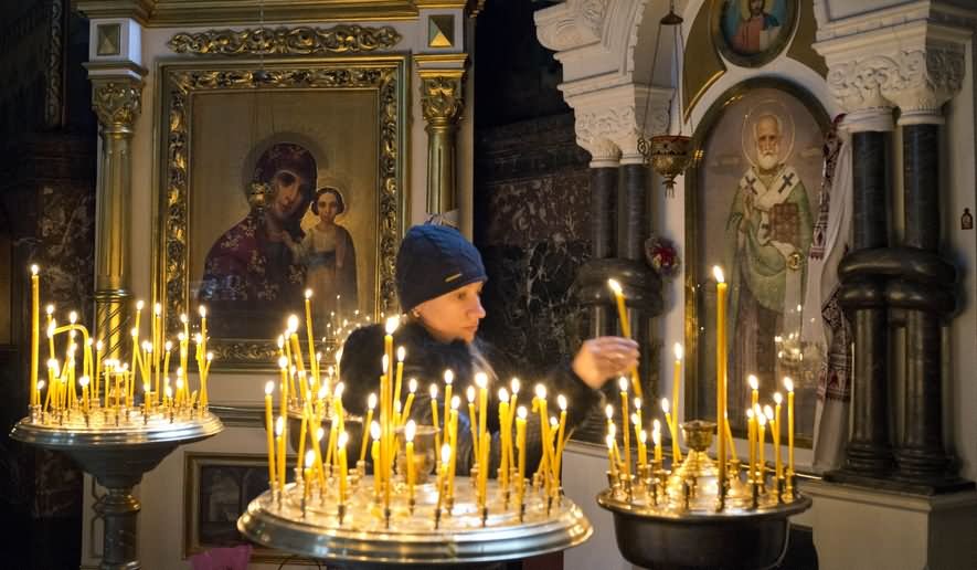 A Women Candles In St Volodymyr's Cathedral