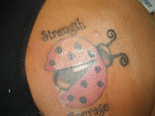 Strength Courage Flying Ladybug Tattoo On Right Back Shoulder