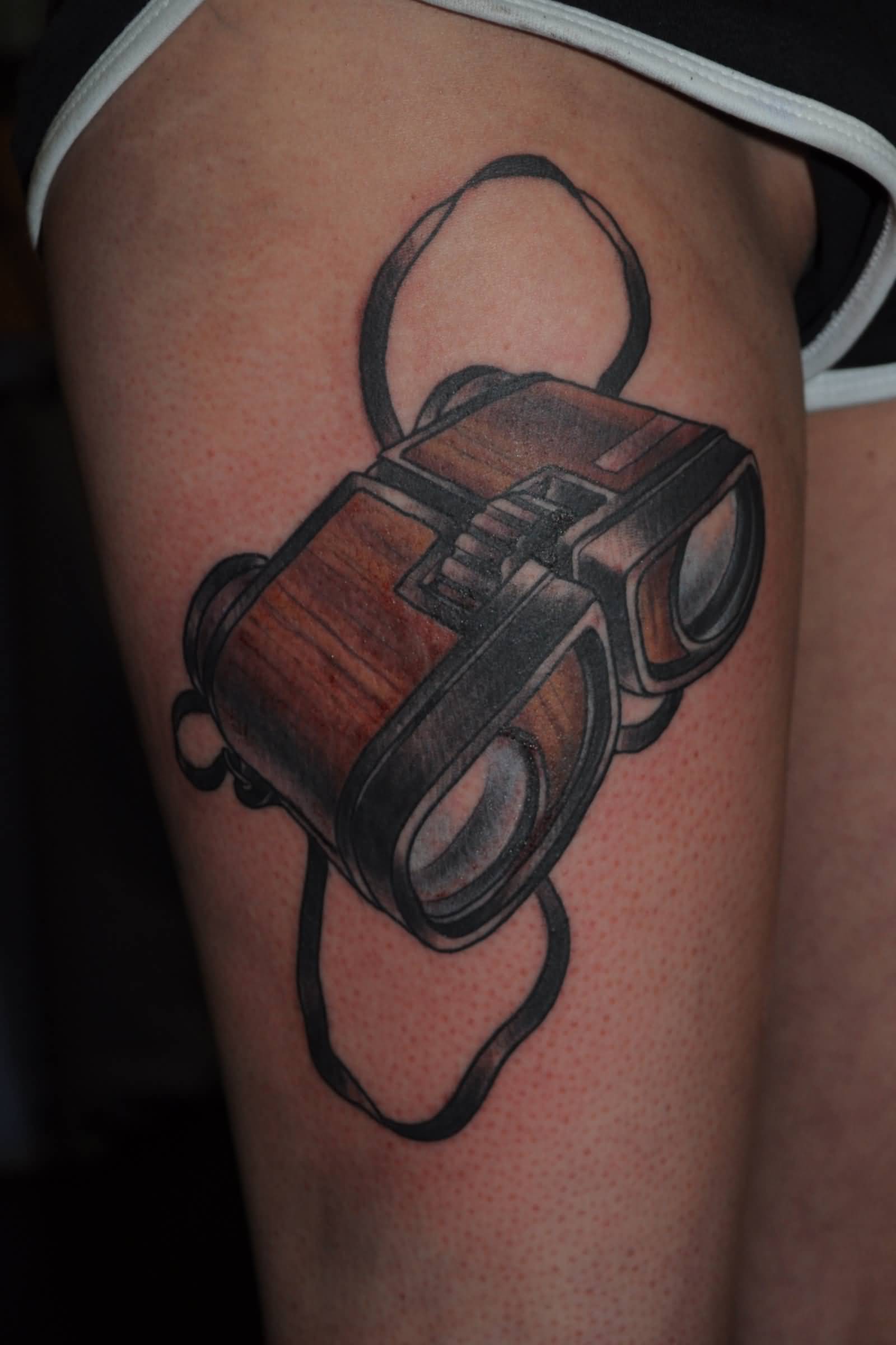 Black And Grey Binoculars Tattoo On Right Thigh