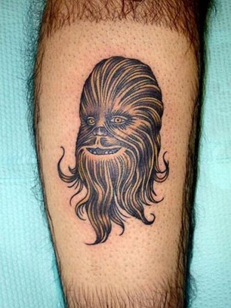 Grey Ink Chewbacca Head Tattoo On Leg