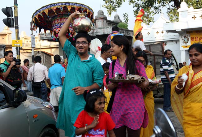 A Family Taking Holy Water From Bagbazar Ghat During Durga Puja Celebrations