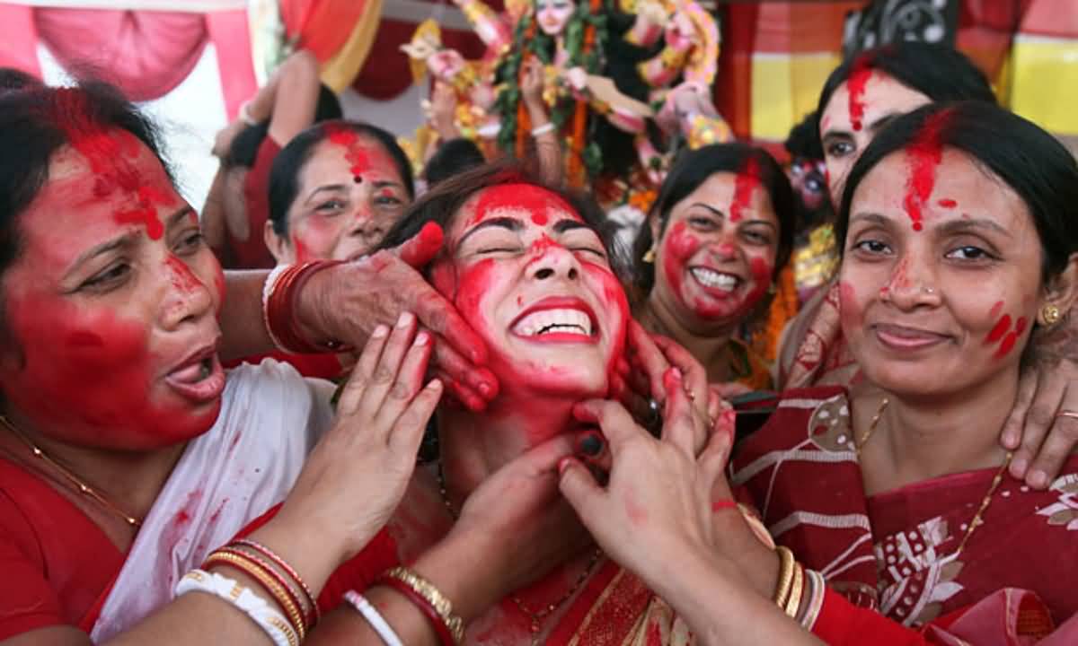 Ladies Playing With Colors During Durga Puja Celebrations