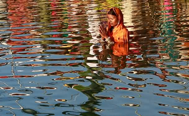 A Woman Taking Holy Dip On The Occasion Of Chhath Puja