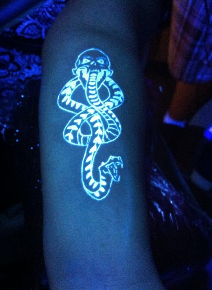 Black Light Snake Tattoo On Left Sleeve