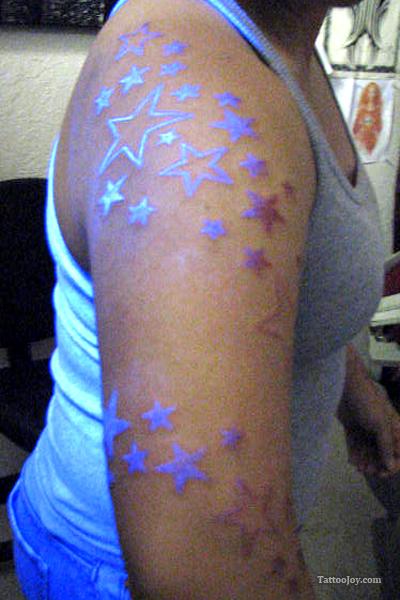 Black Light Stars Tattoos On Girl Right Sleeve