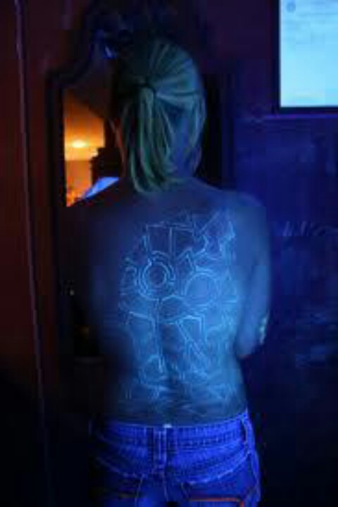 Black Light Tattoo On Girl Full Back