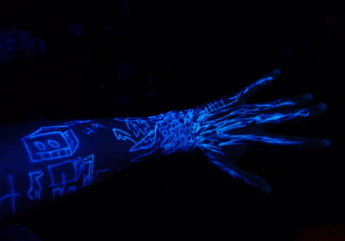 Black Light Tattoo On Left Arm