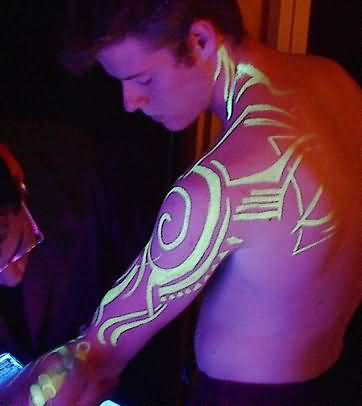 Tribal Black Light Tattoo On Man Left Sleeve