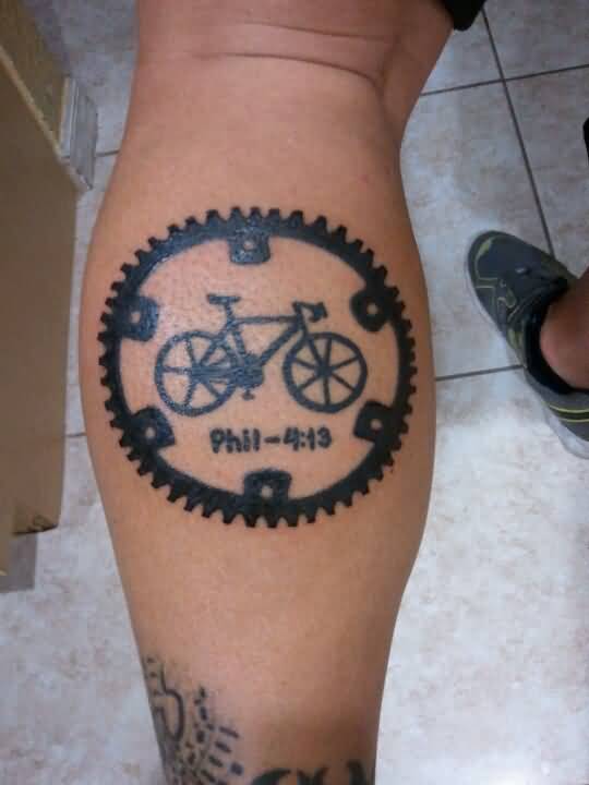 Cycle In Wheel With Phil Silhouette Tattoo On Back Leg