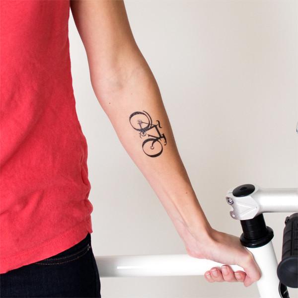 Nice Tiny Black Cycle Tattoo On Forearm