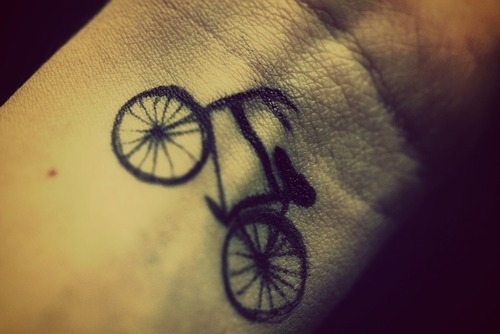 Small Black Ink Cycle Tattoo On Wrist