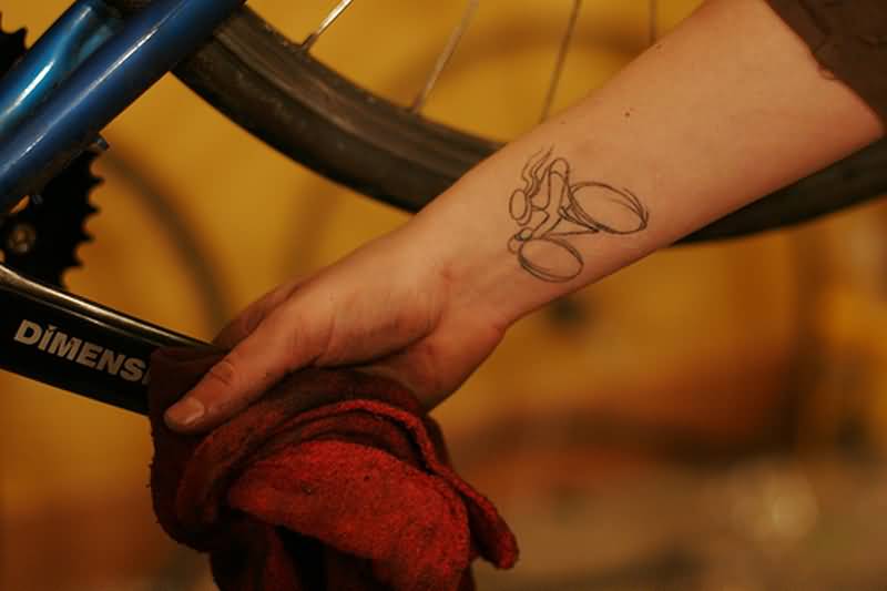 Small Person Riding Cycle Outline Tattoo On Forearm